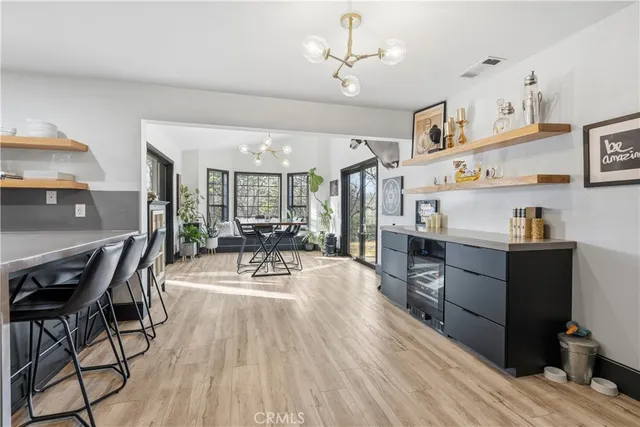 a dining room with furniture a chandelier and wooden floor