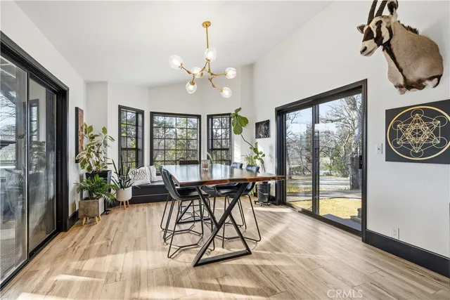 a view of a dining room with furniture large windows and wooden floor