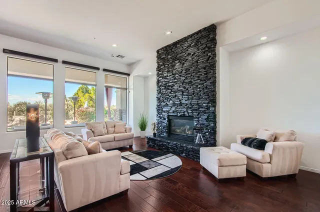 a living room with stainless steel appliances kitchen island granite countertop furniture and a kitchen view