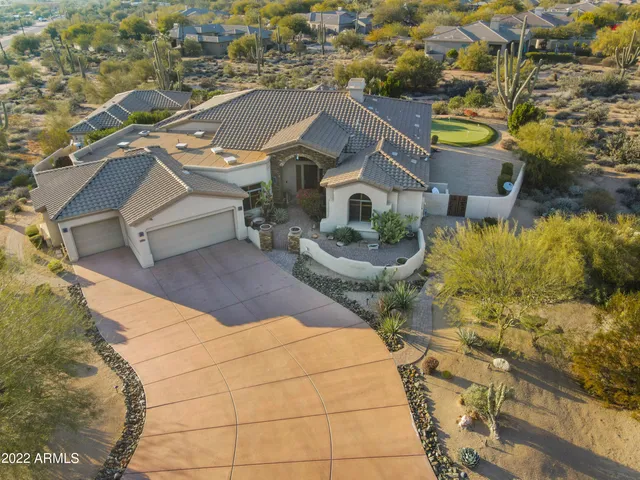 a front view of a house with swimming pool having outdoor seating