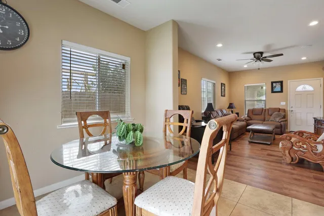 a view of a a dining room with furniture window and wooden floor