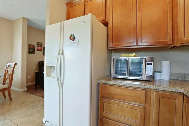 a white refrigerator freezer sitting in a kitchen