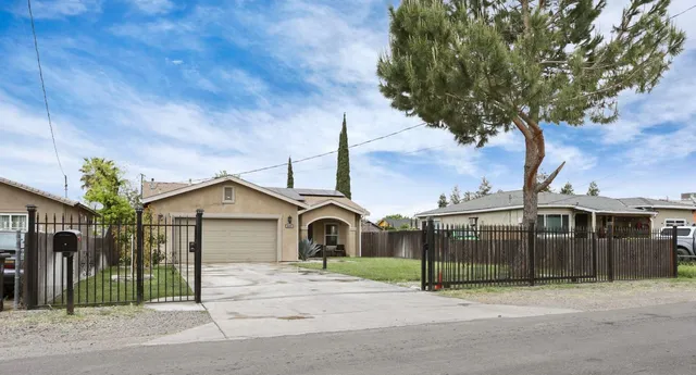 a front view of a house with a garden