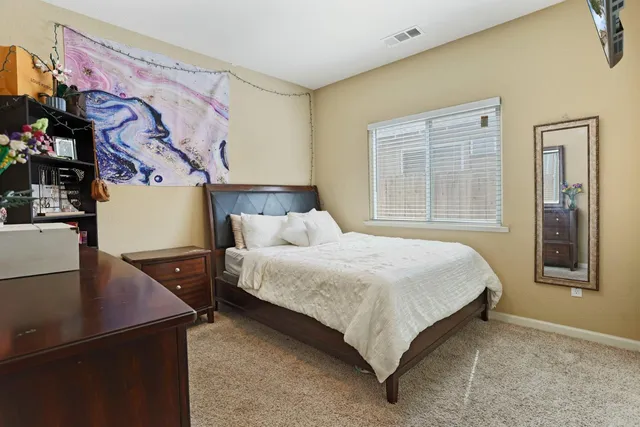 a bedroom with a bed and window