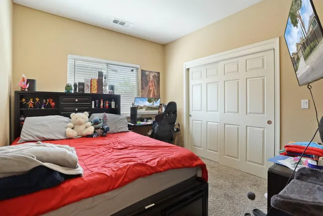 a bedroom with a bed and a couch