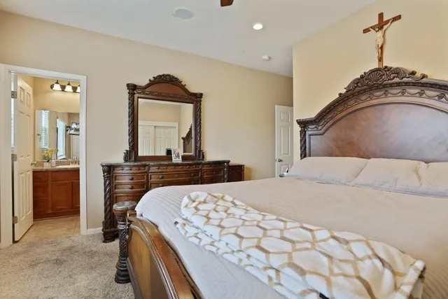 a bedroom with a bed and a mirror