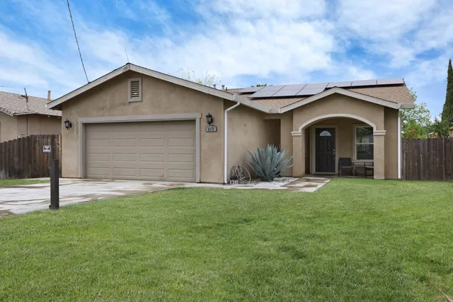 a front view of a house with a yard