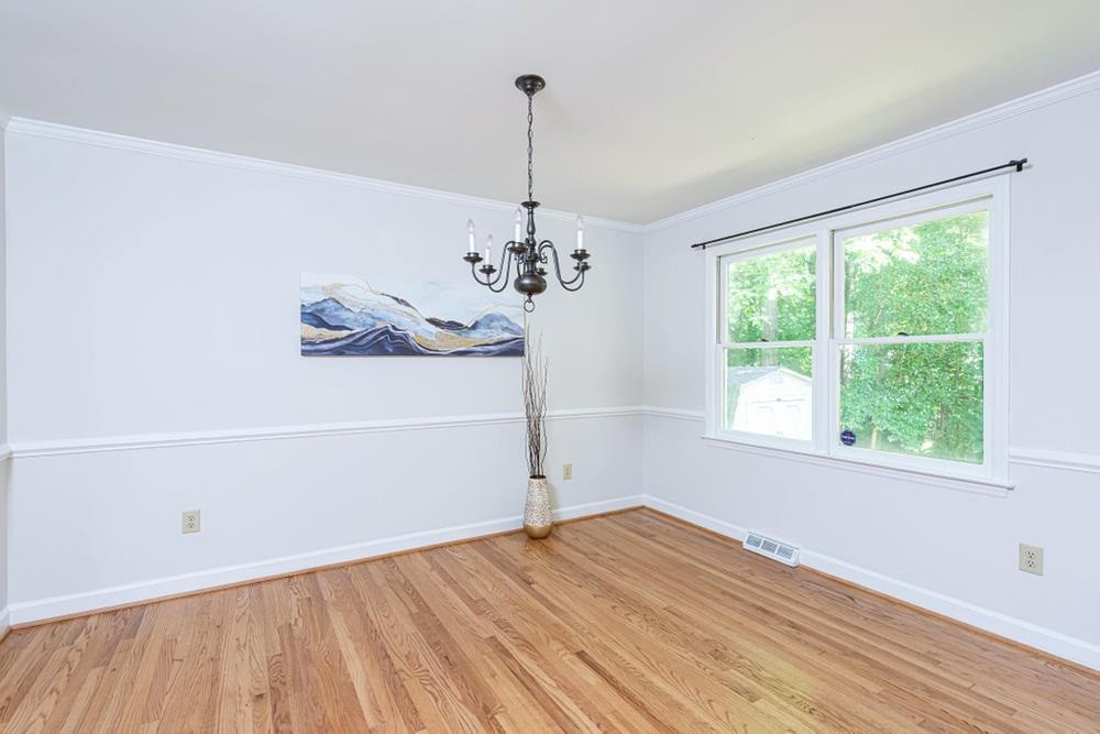509 Compton Road Raleigh, NC 27609 - Photo 5 of 30 Separate Dining Room with chair railing, crown molding, and double window. Dining Room