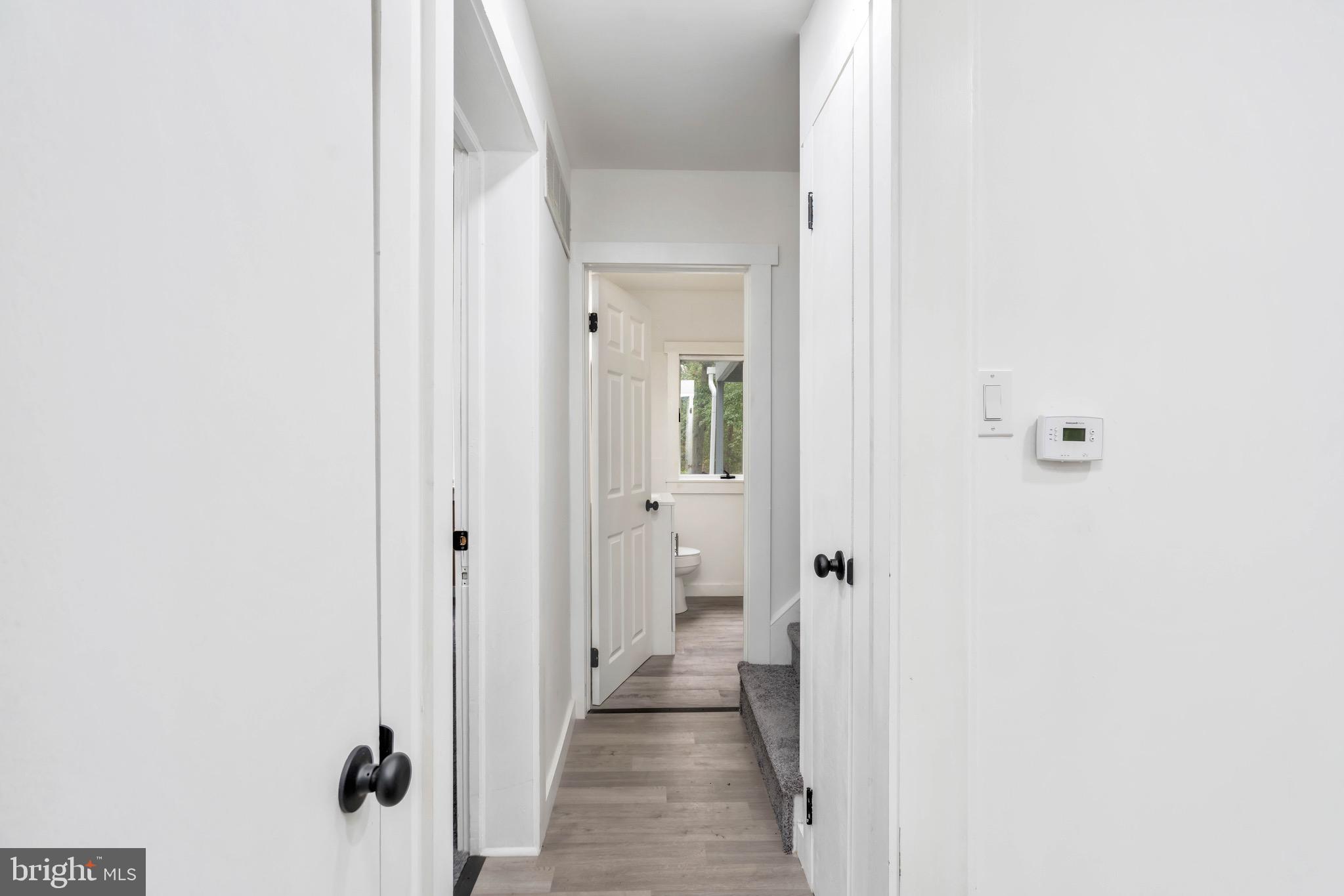 485 Lummistown Road Cedarville, NJ 08311 - Photo 16 of 34 a view of a hallway with wooden floor and a bathroom