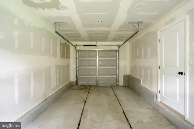 a view of a hallway with wooden stairs