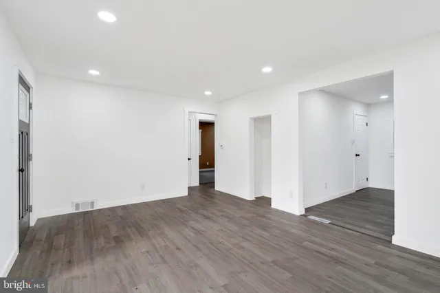 a kitchen with a refrigerator and a stove top oven
