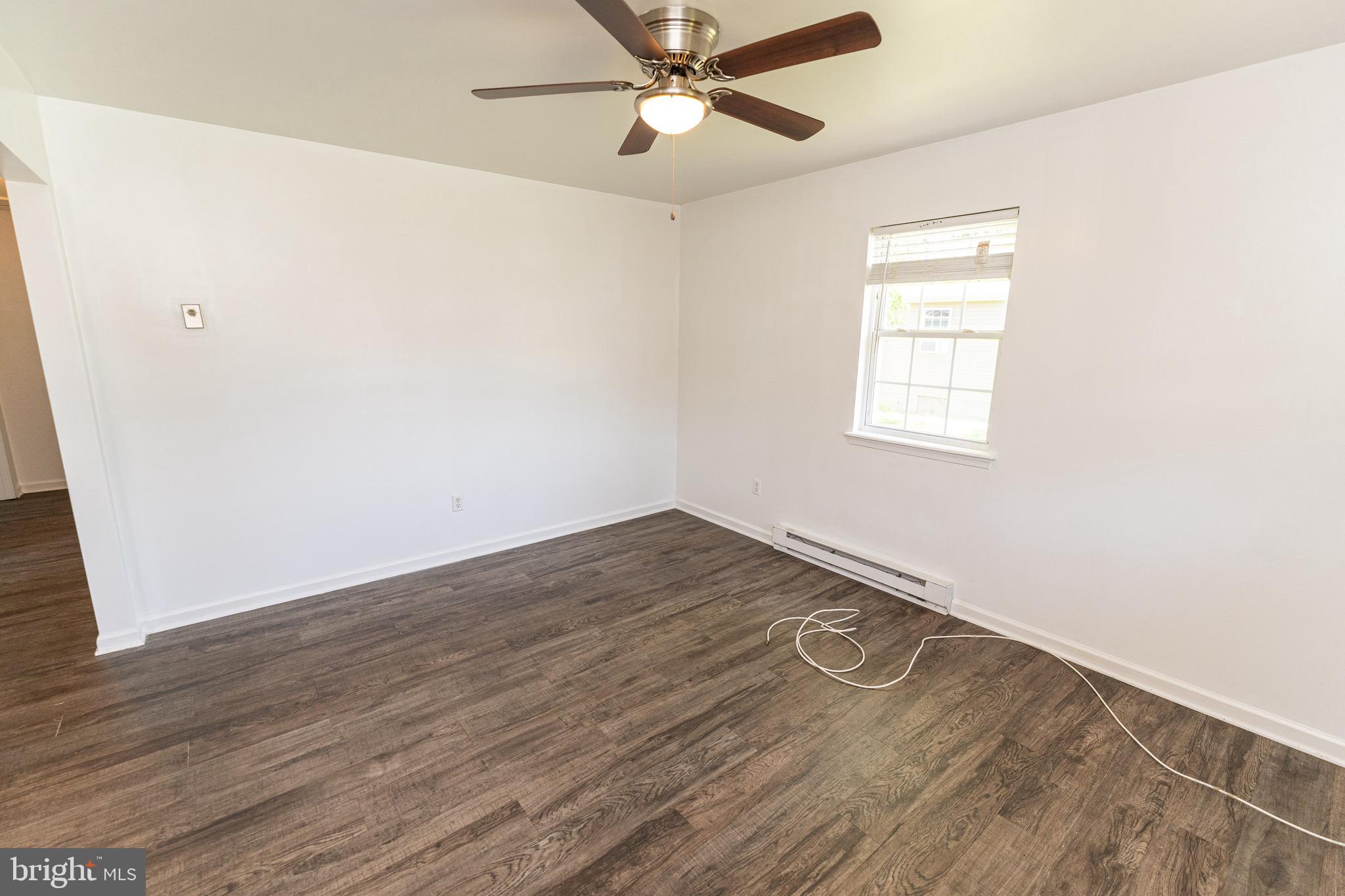 30704 Hampden Avenue Princess Anne, MD 21853 - Photo 9 of 31 an empty room with wooden floor fan and windows