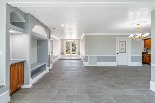 a view of empty room with wooden floor and windows