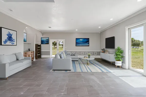 a living room with furniture and a dining table with kitchen view