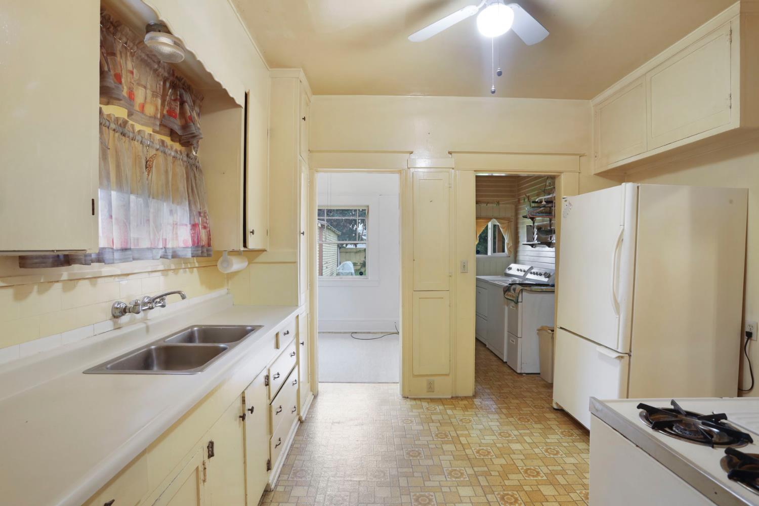 1428 West Harding Way Stockton, CA 95203 - Photo 14 of 32 a kitchen with a sink stove and refrigerator