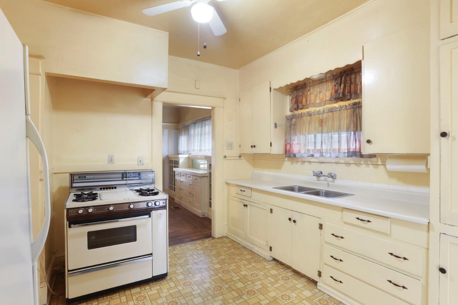 1428 West Harding Way Stockton, CA 95203 - Photo 16 of 32 a kitchen with stainless steel appliances a stove sink and cabinets
