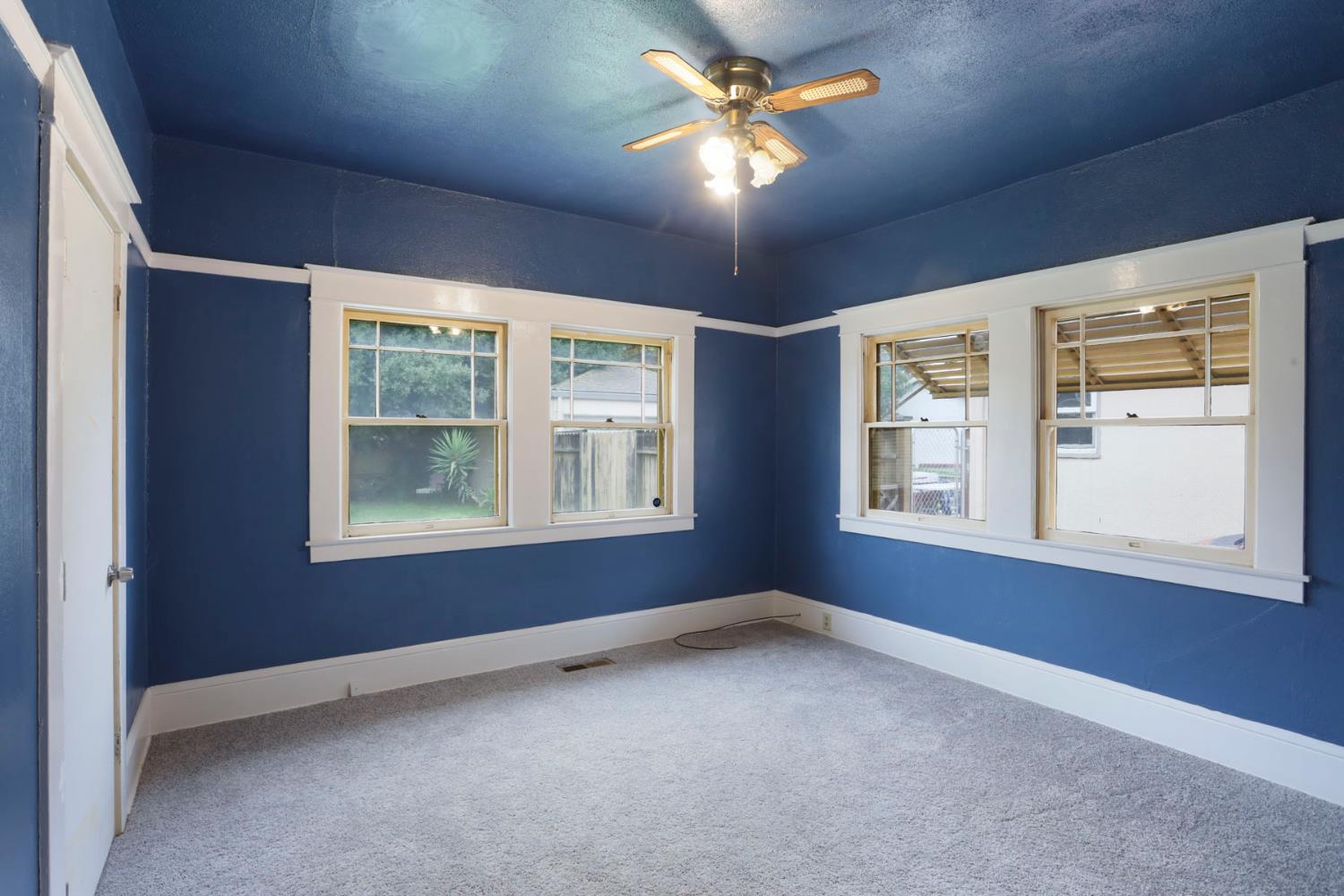 1428 West Harding Way Stockton, CA 95203 - Photo 18 of 32 an empty room with windows and fan