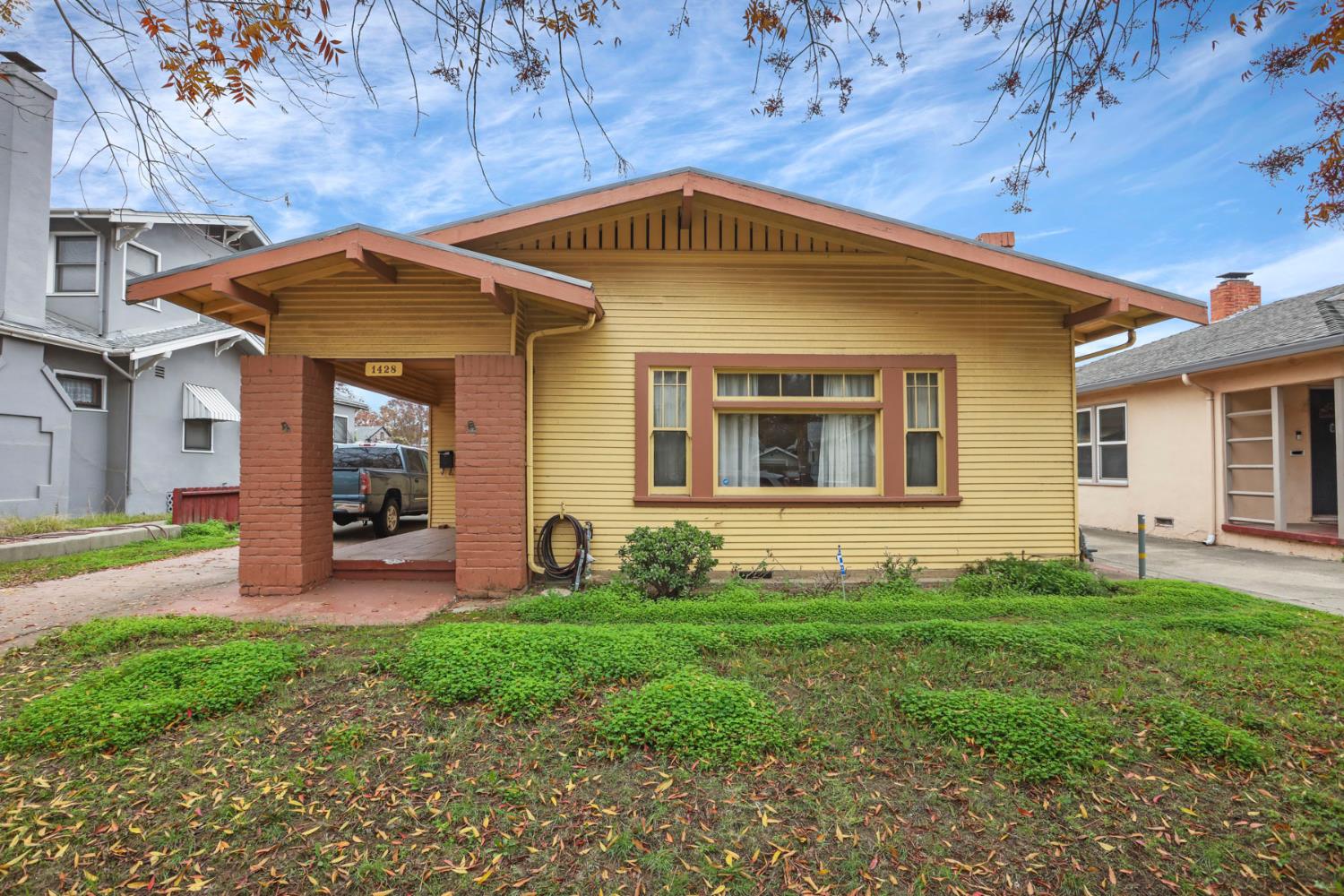 1428 West Harding Way Stockton, CA 95203 - Photo 2 of 32 a front view of a house with a yard