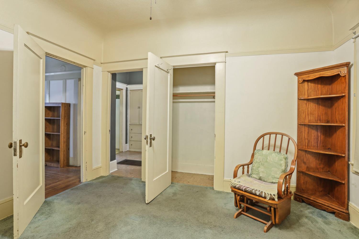 1428 West Harding Way Stockton, CA 95203 - Photo 21 of 32 a view of a bedroom with a chair and door