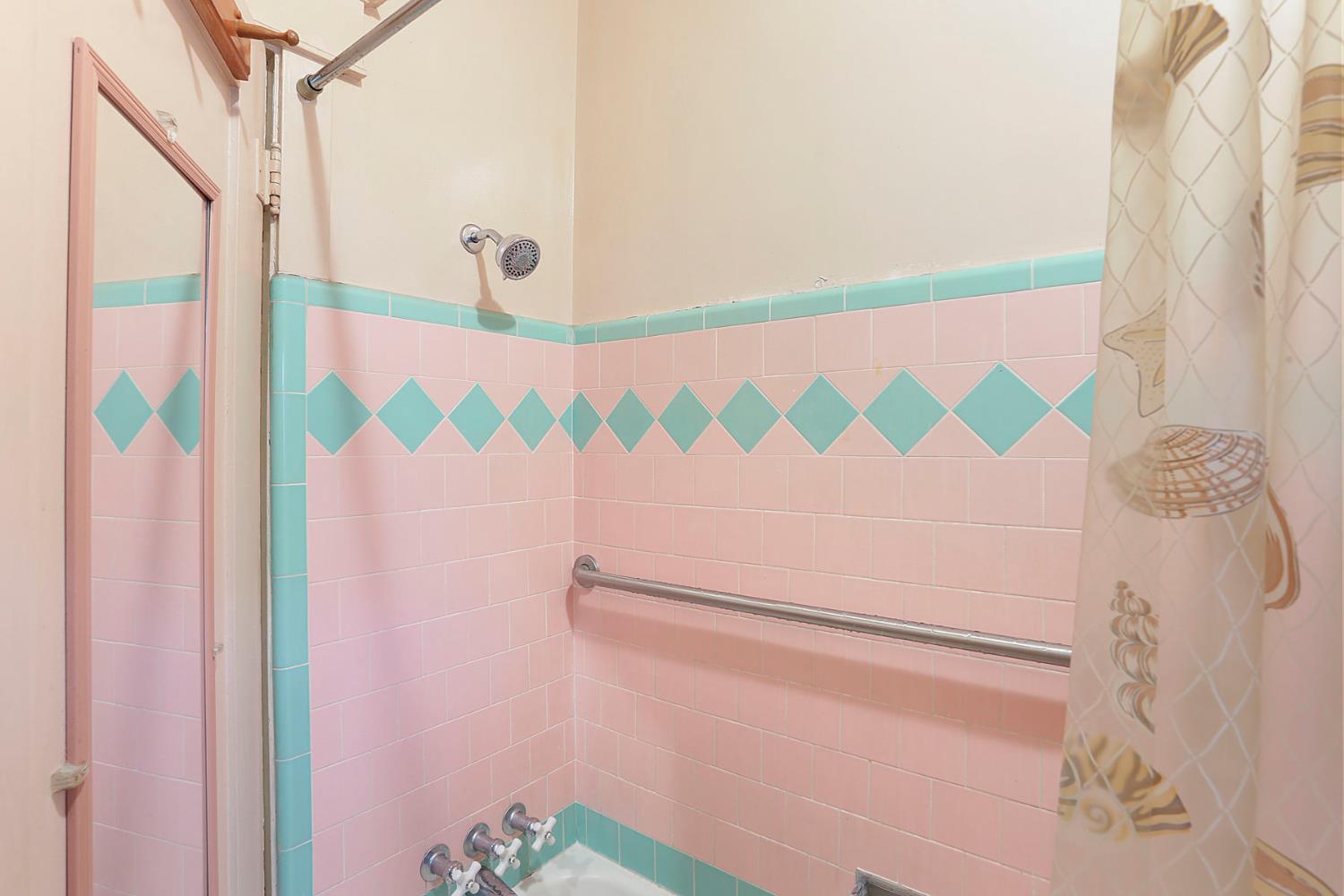 1428 West Harding Way Stockton, CA 95203 - Photo 25 of 32 a bathroom with a sink and a shower curtain