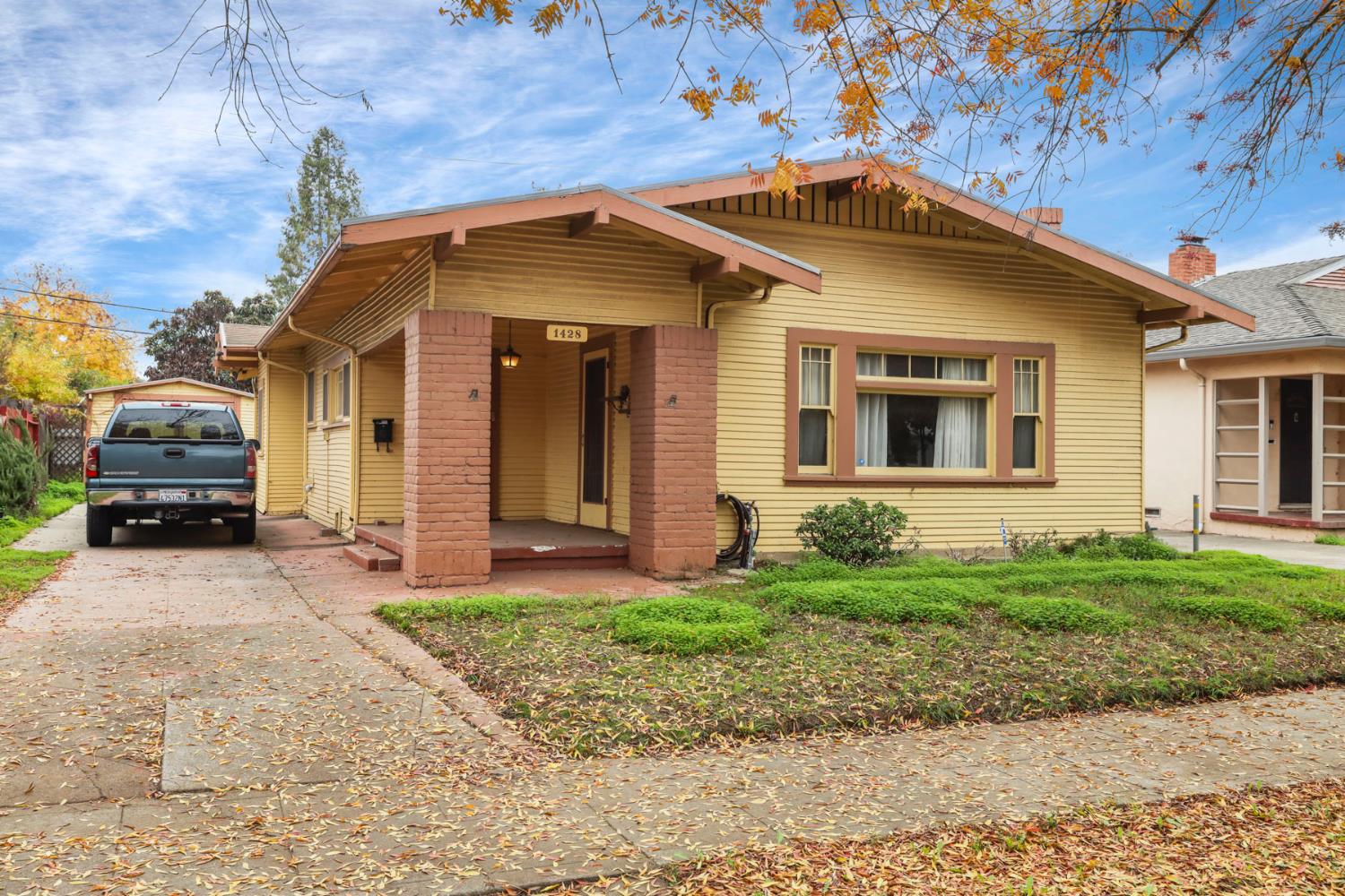 1428 West Harding Way Stockton, CA 95203 - Photo 3 of 32 a front view of a house with a yard
