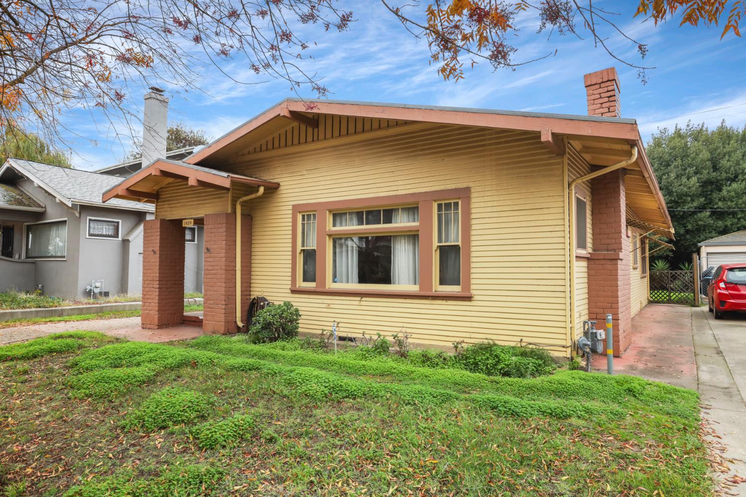 1428 West Harding Way Stockton, CA 95203 - Photo 5 of 32 a front view of a house with a yard