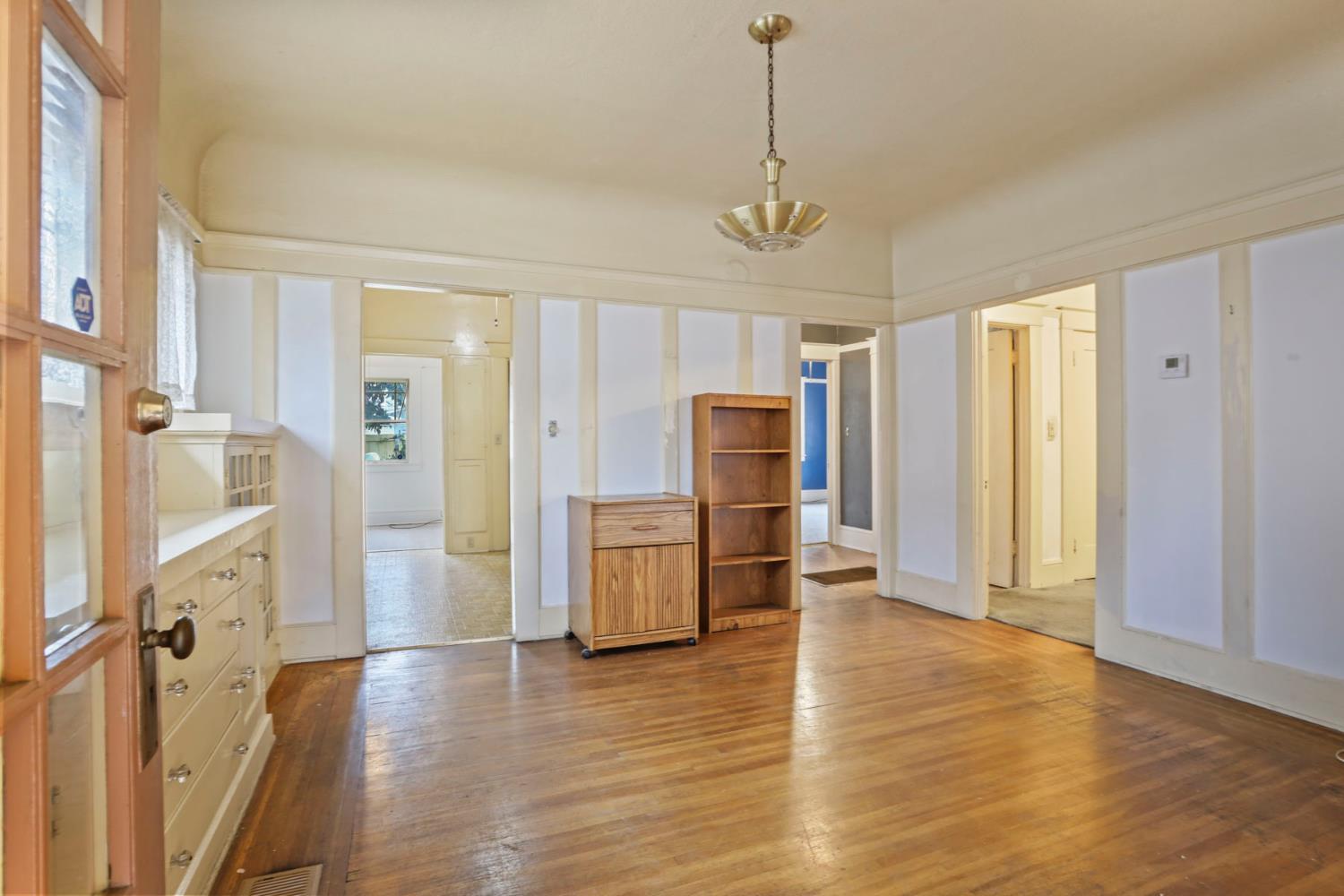1428 West Harding Way Stockton, CA 95203 - Photo 6 of 32 a view of a hallway with wooden floor and windows