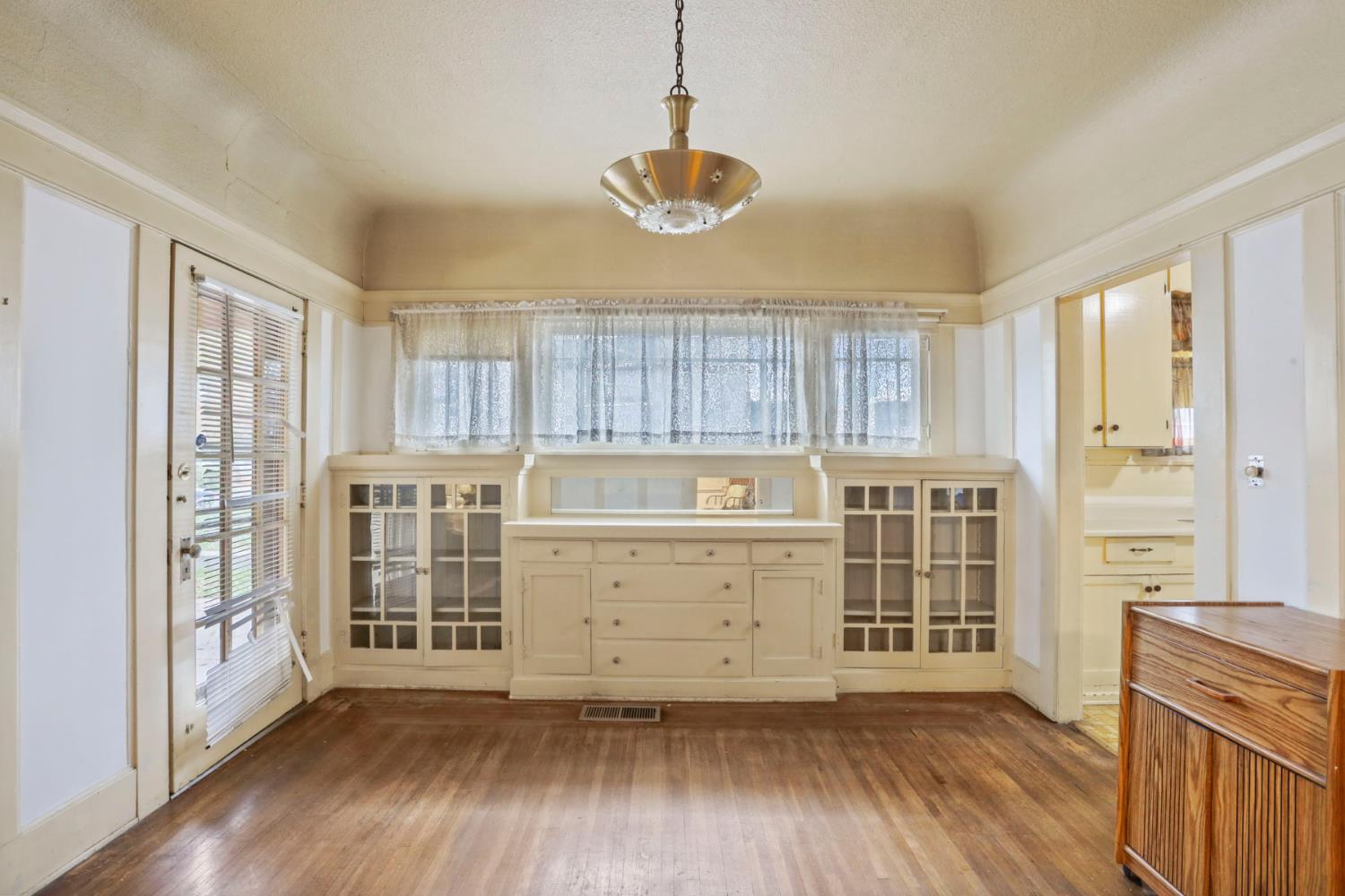 1428 West Harding Way Stockton, CA 95203 - Photo 7 of 32 a view of a room with wooden floor and cabinet