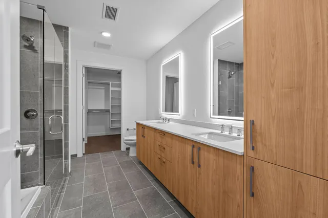 a bathroom with a double vanity sink and a mirror