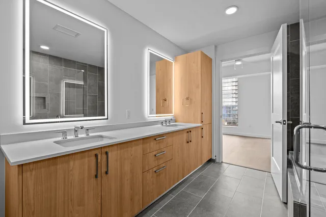 a bathroom with a double vanity sink and a mirror