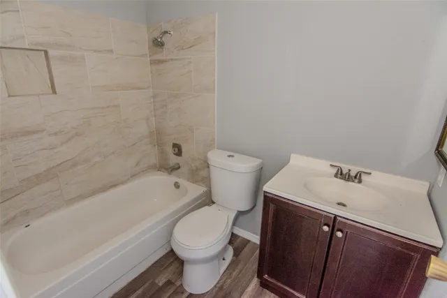 a bathroom with a sink a toilet and bathtub