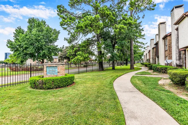 a view of a garden with a house in the background