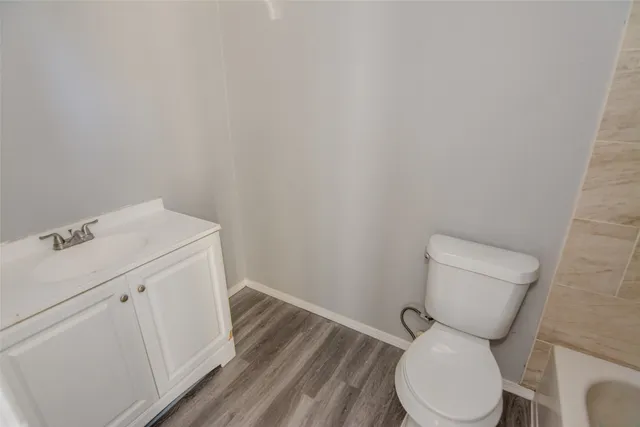 a white toilet sitting next to a bathroom sink