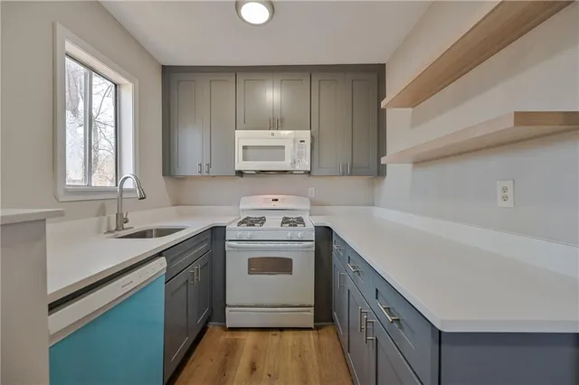a kitchen with a sink a stove and cabinets