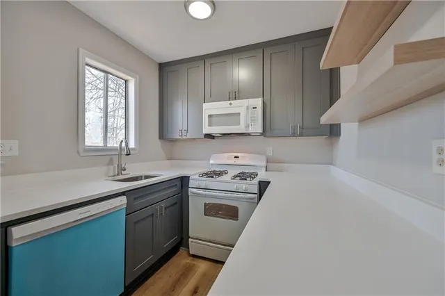 a kitchen with a sink cabinets and window