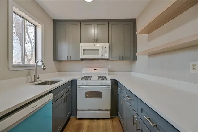 a kitchen with a sink stove and cabinets