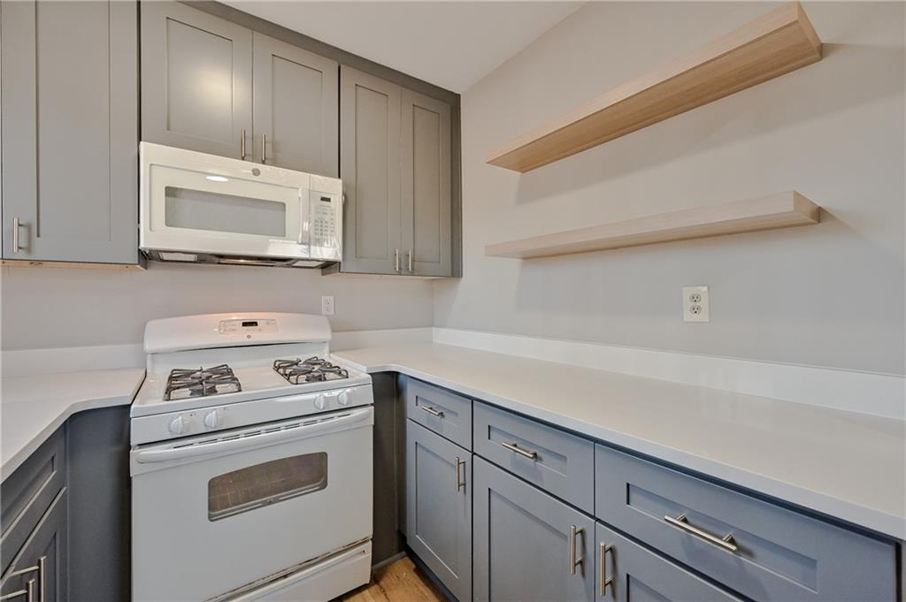 955 Tilden Street Northwest Atlanta, GA 30318 - Photo 14 of 25 a kitchen with cabinets appliances and a counter space