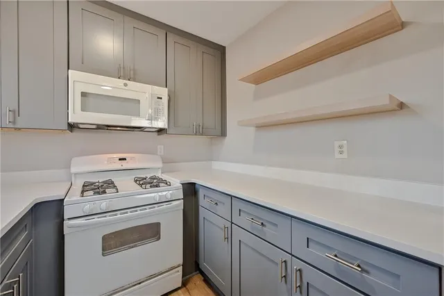 a kitchen with cabinets appliances and a counter space