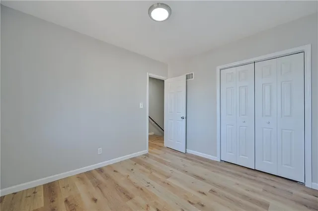a view of an empty room and wooden floor