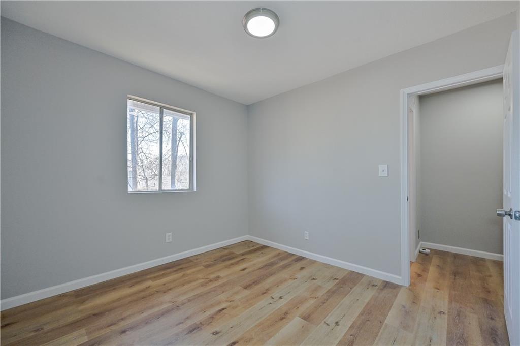 955 Tilden Street Northwest Atlanta, GA 30318 - Photo 22 of 25 an empty room with wooden floor and windows