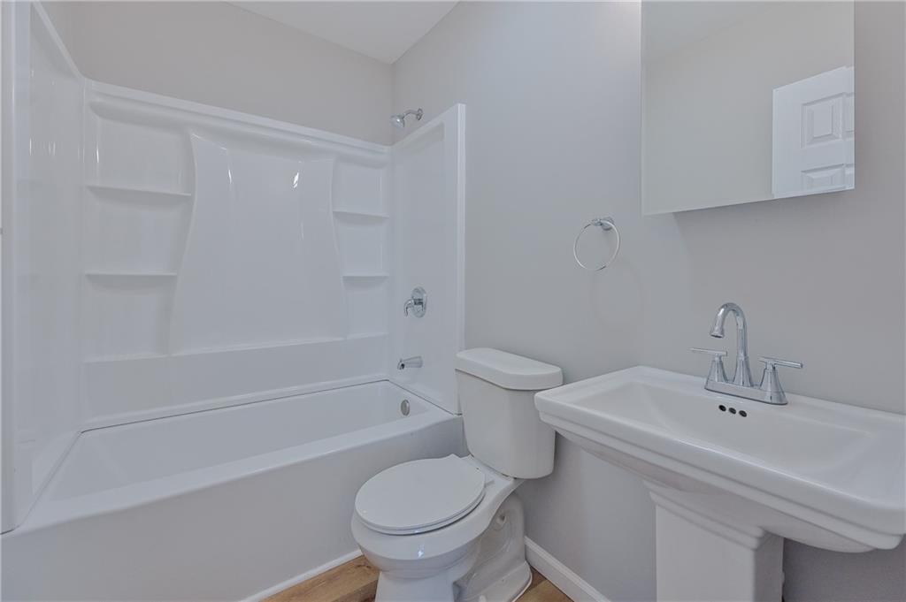 955 Tilden Street Northwest Atlanta, GA 30318 - Photo 23 of 25 a bathroom with a sink and a toilet