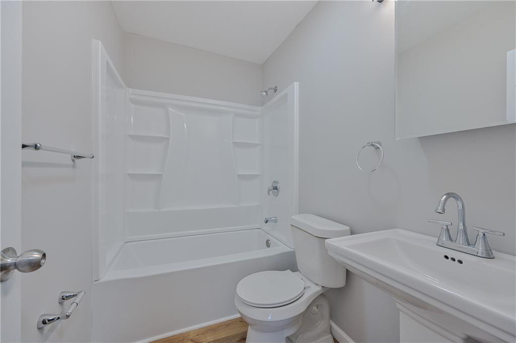 955 Tilden Street Northwest Atlanta, GA 30318 - Photo 24 of 25 a bathroom with a sink a toilet and shower