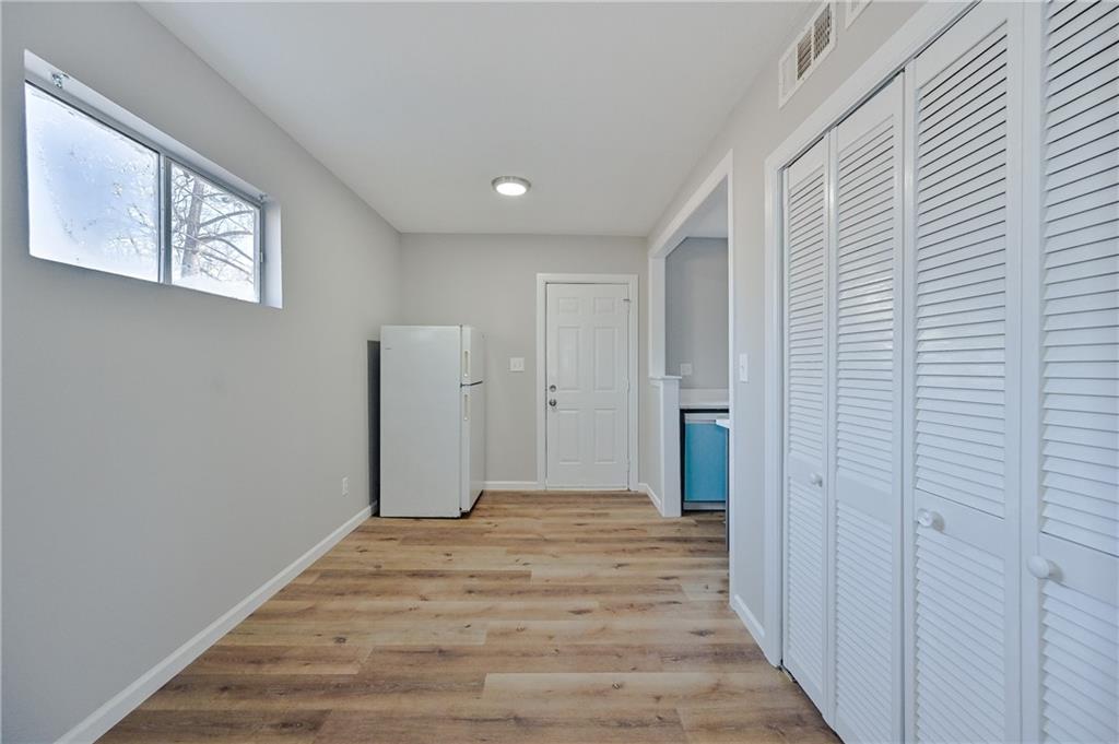 955 Tilden Street Northwest Atlanta, GA 30318 - Photo 6 of 25 a view of a room with wooden floor and closet