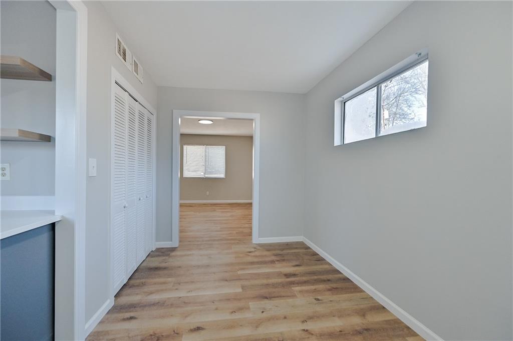 955 Tilden Street Northwest Atlanta, GA 30318 - Photo 7 of 25 a view of a hallway with wooden floor and closet