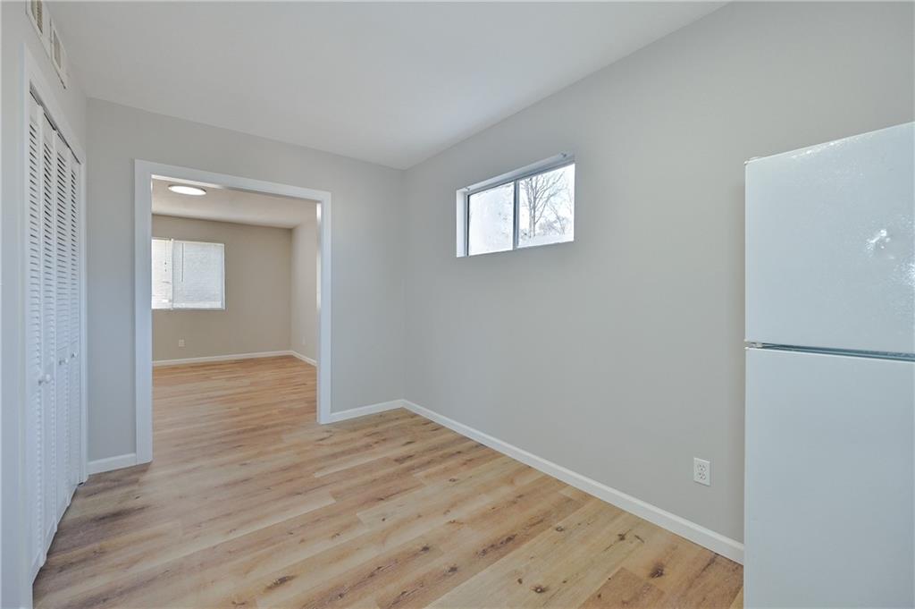 955 Tilden Street Northwest Atlanta, GA 30318 - Photo 8 of 25 a view of an empty room with wooden floor and a window