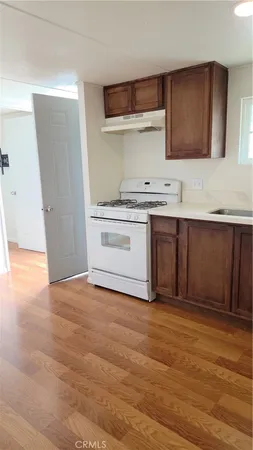 a kitchen with stainless steel appliances granite countertop a sink and a stove top oven