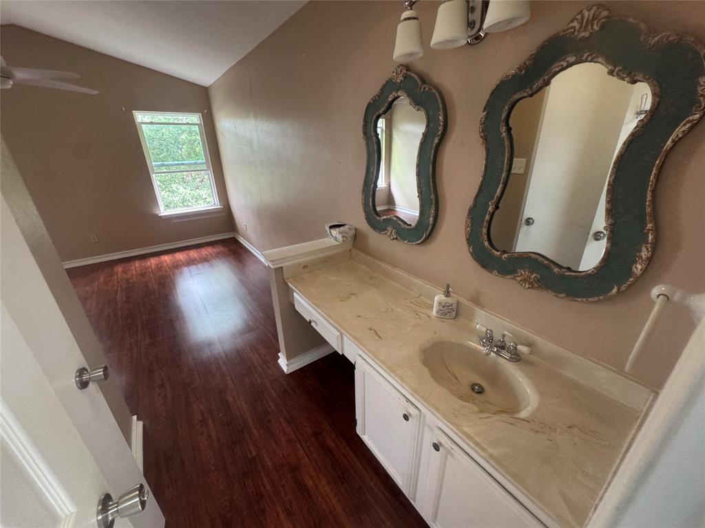 4649 Misty Ridge Drive Fort Worth, TX 76137 - Photo 5 of 25 a bathroom with a granite countertop sink a mirror and vanity