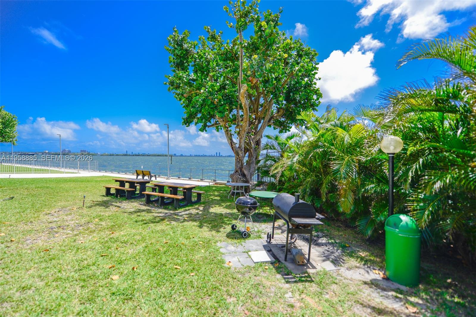 880 Northeast 69th Street, Unit 2N Miami, FL 33138 - Photo 13 of 23 a view of a backyard with chairs and a fire pit