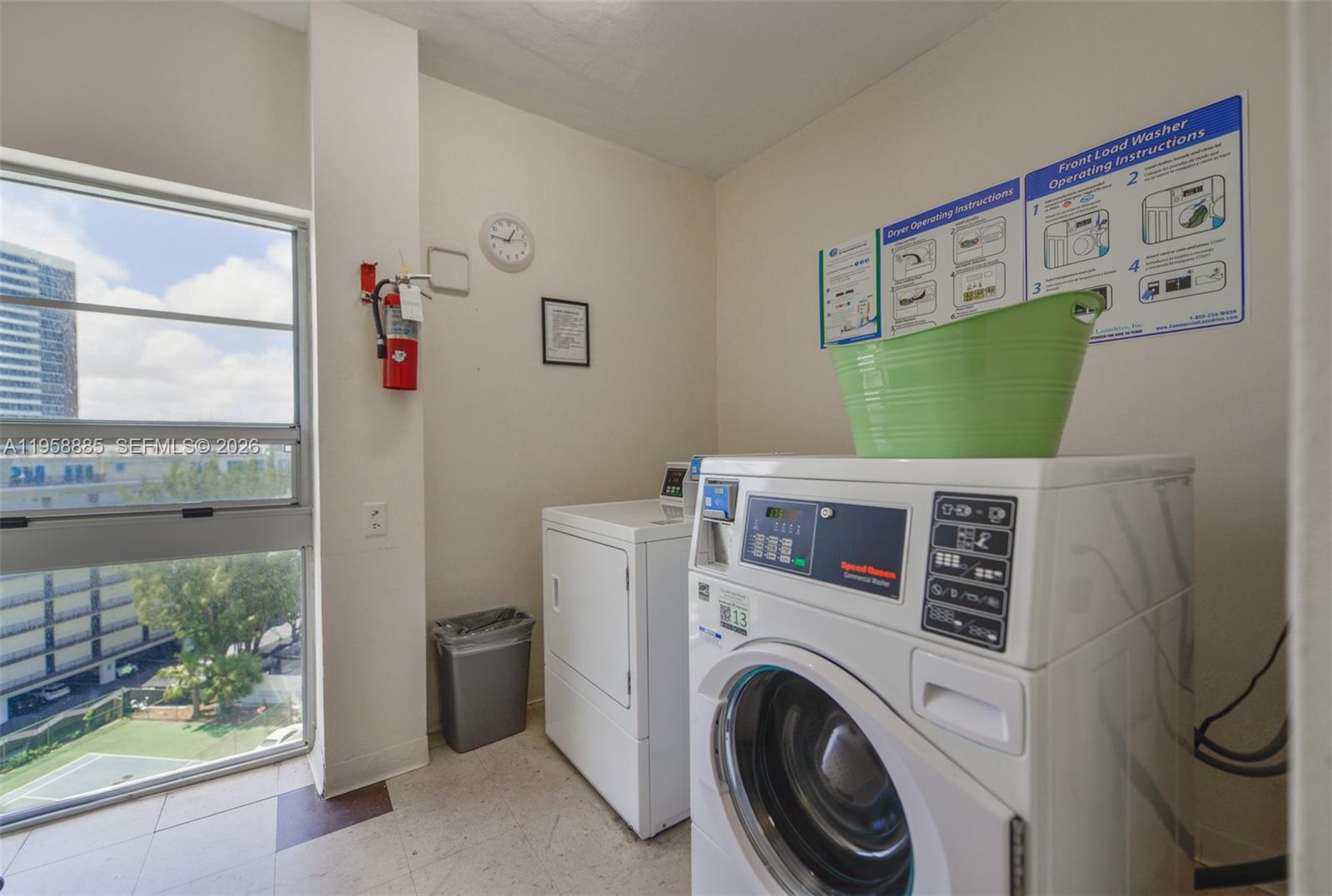 880 Northeast 69th Street, Unit 2N Miami, FL 33138 - Photo 16 of 23 a room with a washer and dryer