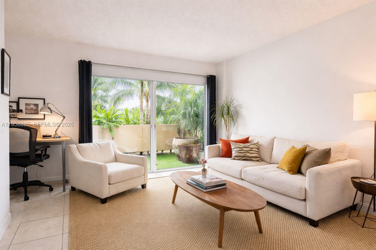 880 Northeast 69th Street, Unit 2N Miami, FL 33138 - Photo 17 of 23 a living room with furniture and a large window
